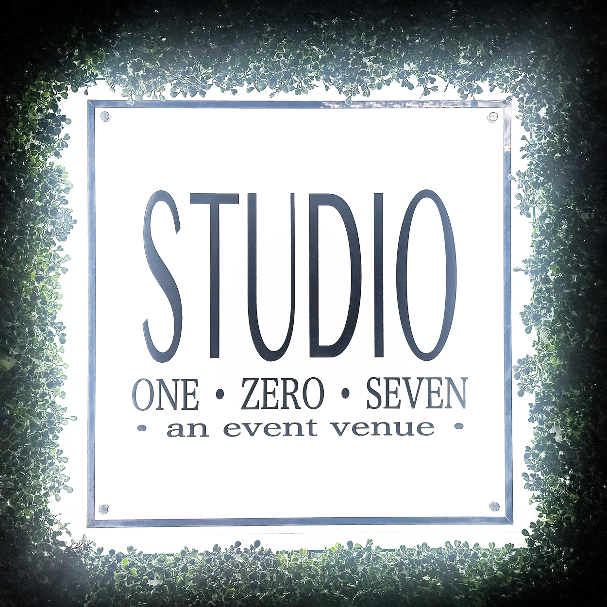 Studio 107 sign in a grass wall